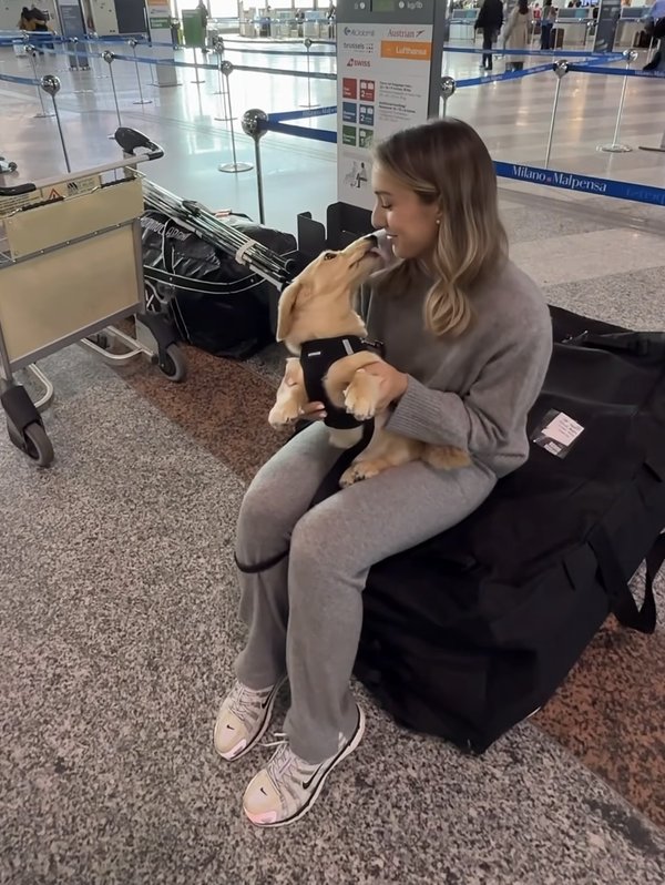 Happy client with their dog at the airport gate